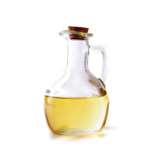 Yellow sunflower, hemp or olive oil in a bottle with a wooden stopper on a white background.